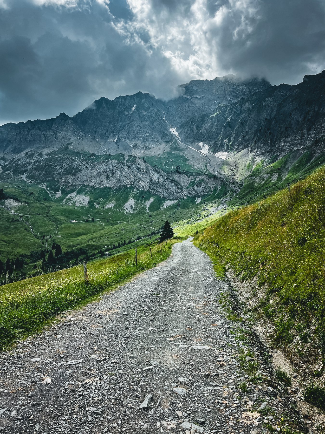 Storm clouds over an alpine gravel road