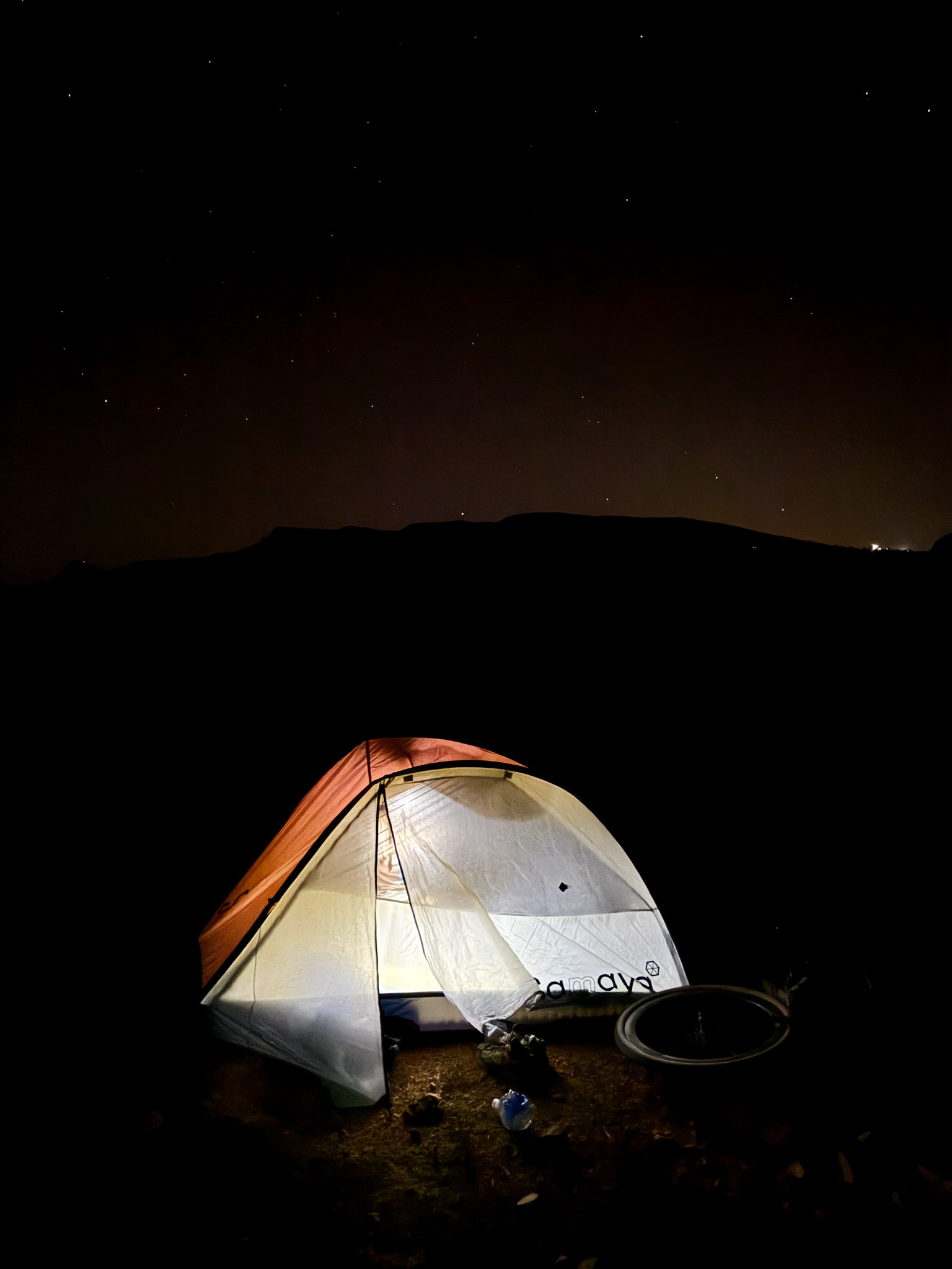 Tent glowing at night during the bikepacking trip