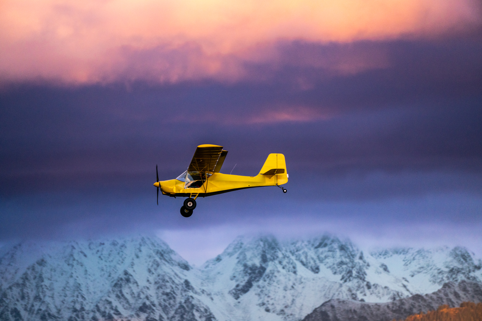 Yellow plane over the mountains